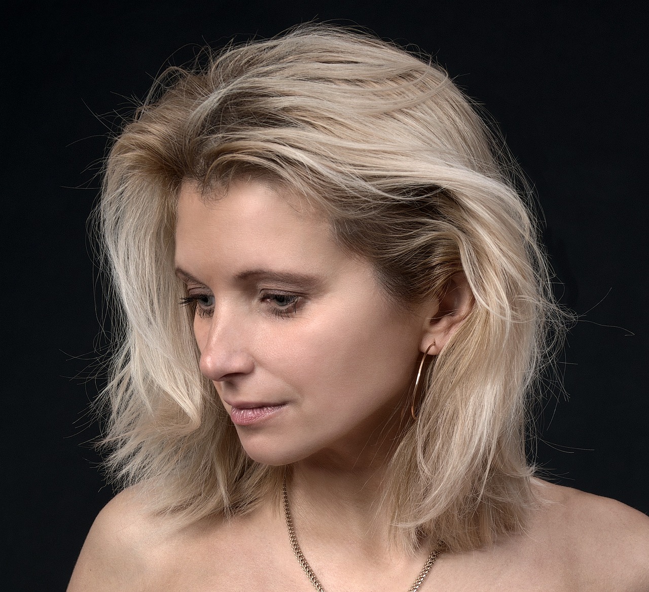 Editorial style portrait of a mature latina woman with glowing skin
